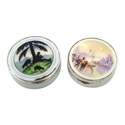 Silver enamel circular compact, the lid decorated with a silhouette of a Shepherd playing a recorder and sheep by Cohen & Charles, London 1920 and one other, the lid decorated with a Venetian landscape, by H C Freeman Ltd, London import marks 1927 and one other, (2)