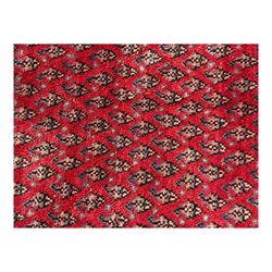 Persian Arak crimson ground rug, the field decorated with repeating Boteh motifs within geometric guard stripes