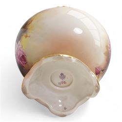 1920s Royal Worcester porcelain rose bowl, the flattened baluster body hand painted with roses and foliage, below a flared gilt pierced border, raised upon scroll moulded quatrefoil foot, shape no. H166, H13cm, together with a similarly decorated Royal Worcester bowl (2)