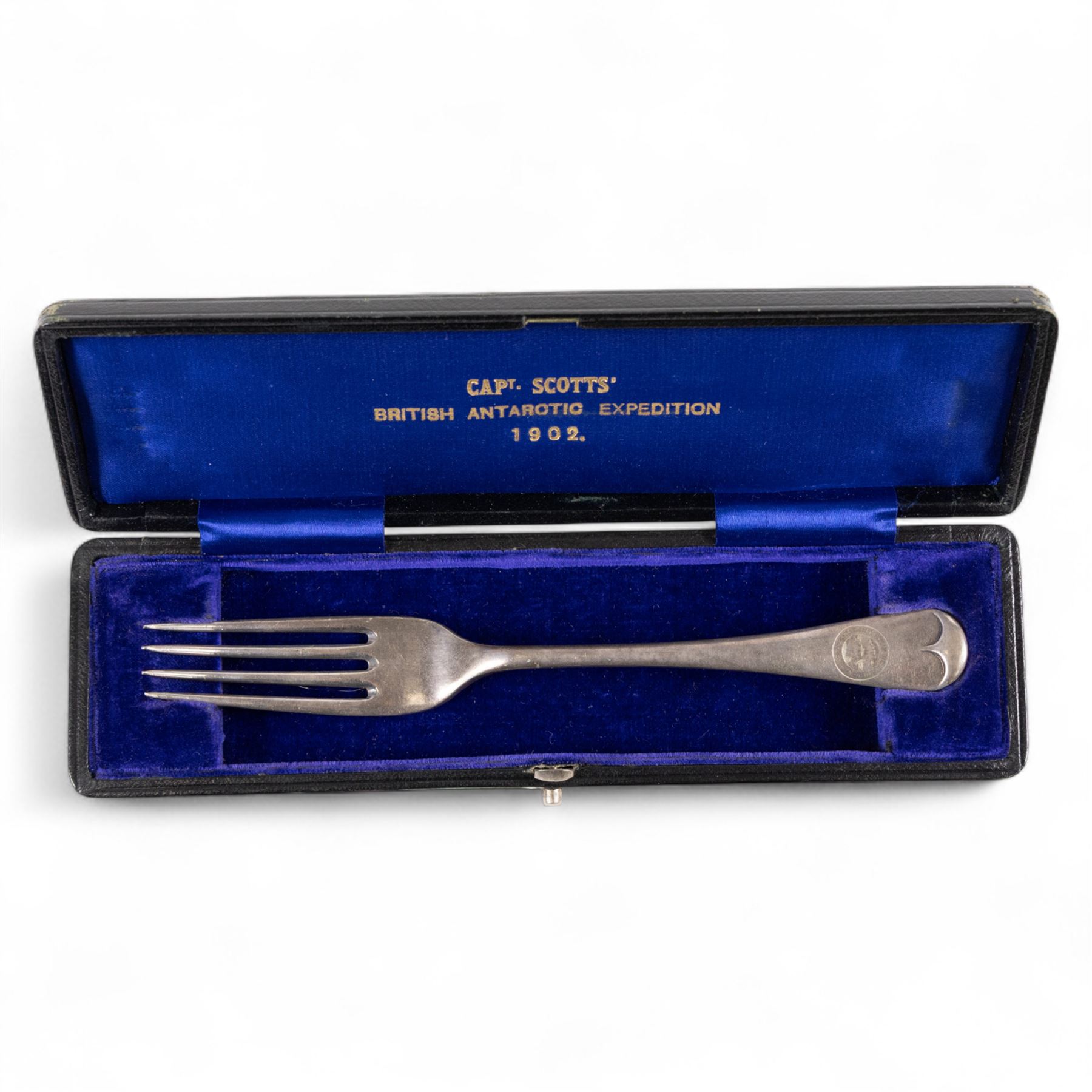 Capt Scotts' British National Antarctic Expedition 1901-1904: table fork from relief ship SY Morning, an electroplated nickel silver table fork, engraved with circular crest reading 'National Antarctic Expedition SY Morning', the fork with maker's mark for Daniel and Arter Ltd, Birmingham, stamped with trade name 'Nevada Silver', in tooled leather case impressed with gilt initials 'AMHC', with blue silk and velvet interior, the gilt lettering to interior reading 'Capt Scotts' British Antarctic Expedition'

Notes: The SY Morning was a steam yacht that served as a relief and resupply vessel for Captain Scott's Discovery during the British National Antarctic Expedition 1901-1904