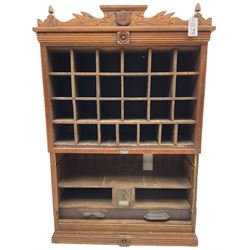 19th century stained pitch pine 'US Mail' pigeonhole unit, raised carved gallery with applied inscribed shield plaque, fitted with twenty five pigeon holes over shelves and correspondence drawers