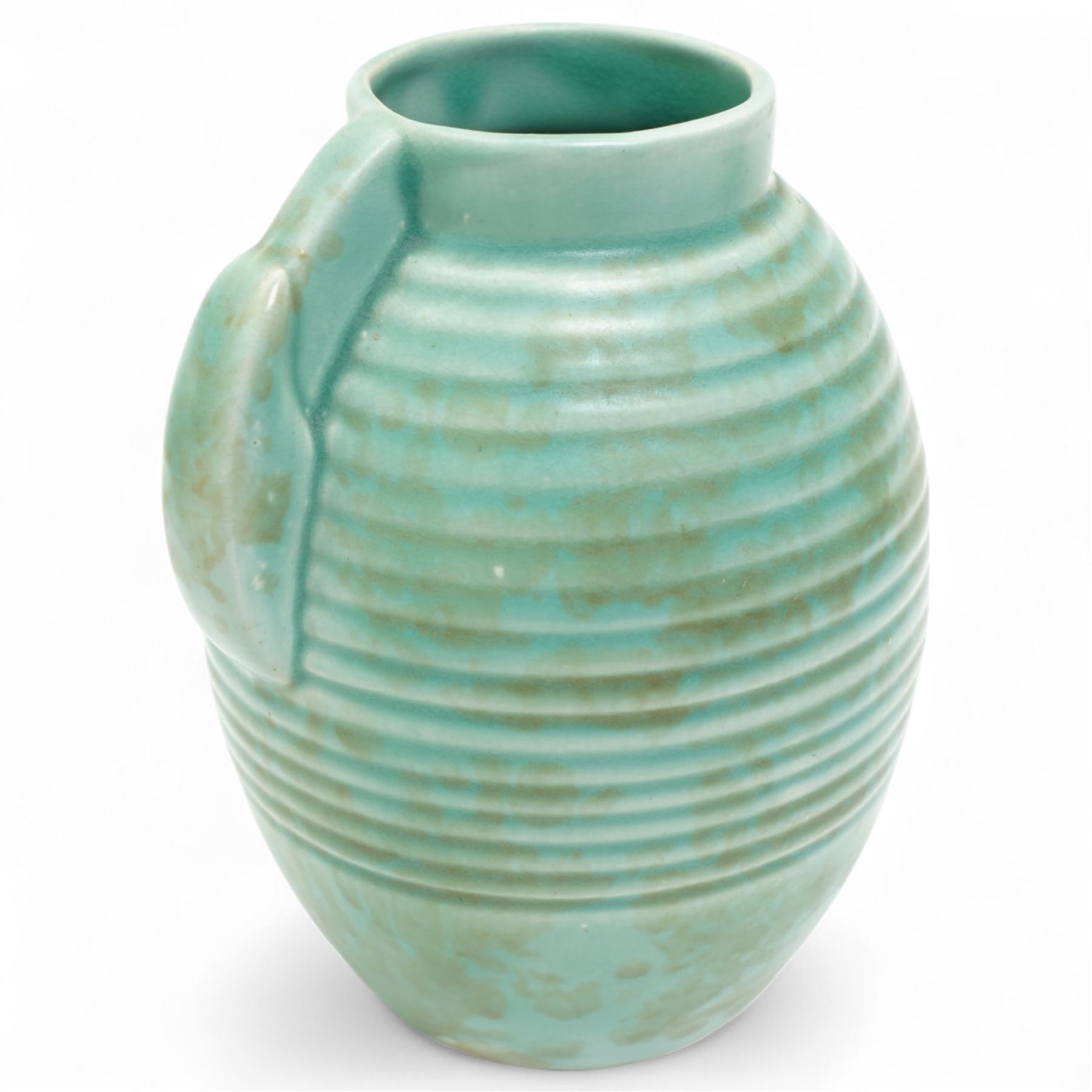 Susie Cooper pottery jug, the green glazed body with ring turned and dimpled decoration, inscribed 'Susie Cooper, England' to base, H23cm; together with two similar art deco pottery jugs with similar decoration, by Price Brothers and Ditmar Urbach, larger H21cm (3)