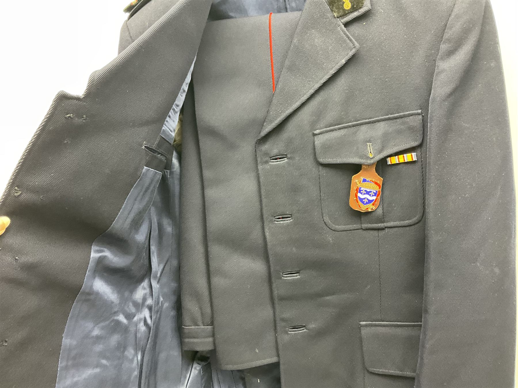 Mid 20th century French Ugeco Nantes first class dress navy blue uniform with ribbon bar with cap, and quantity of Sapeurs Pompiers patches, Sapeurs Pompiers de Caen belt buckle etc