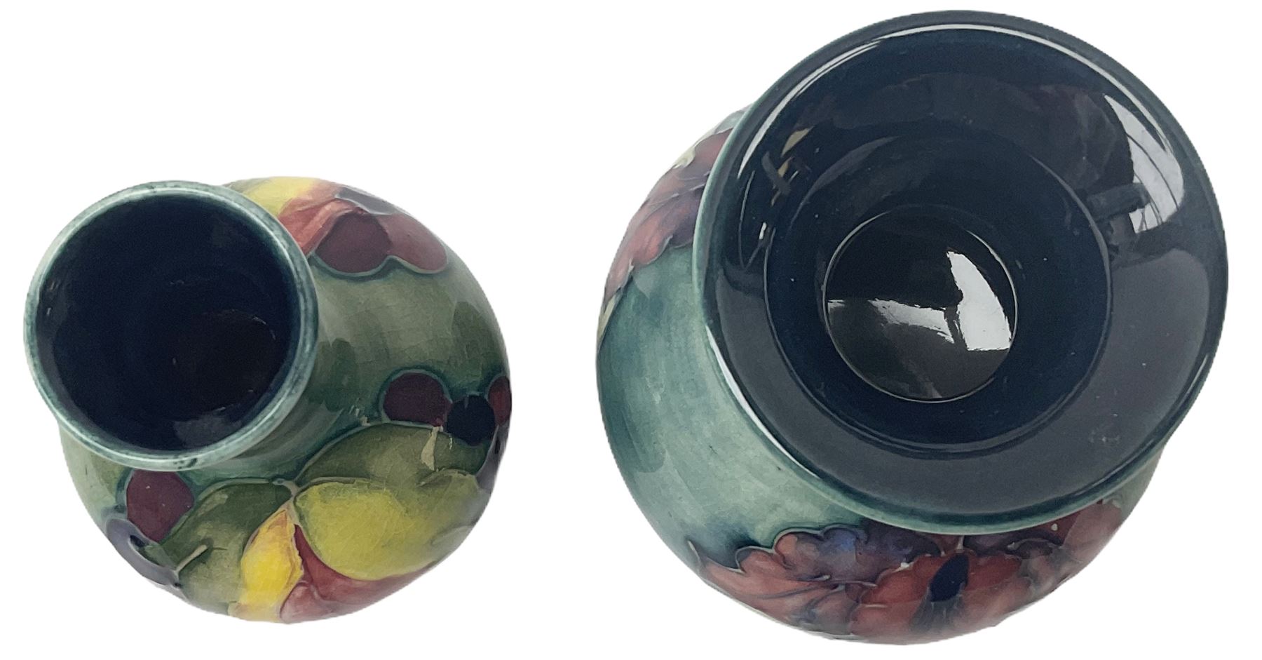 Moorcroft vase, decorated in the Leaf and Berries pattern upon a tonal green ground, together with a further Moorcroft vase, of squat baluster form, decorated in the Iris pattern upon a tonal green ground, each with impressed marks beneath, each H9cm. 