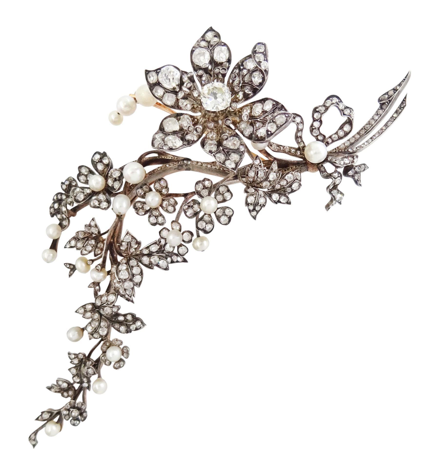 19th century gold and silver diamond and pearl en tremblant detachable brooch, the flower tremblant with a principal old cut diamond of approx 1.90 carat, the petals and stamen set with old cut and rose cut diamonds, total diamond weight approx 9.10 carat, to a foliate spray set set with further rose cut diamond and white / pink / cream pearls and ribbon tie