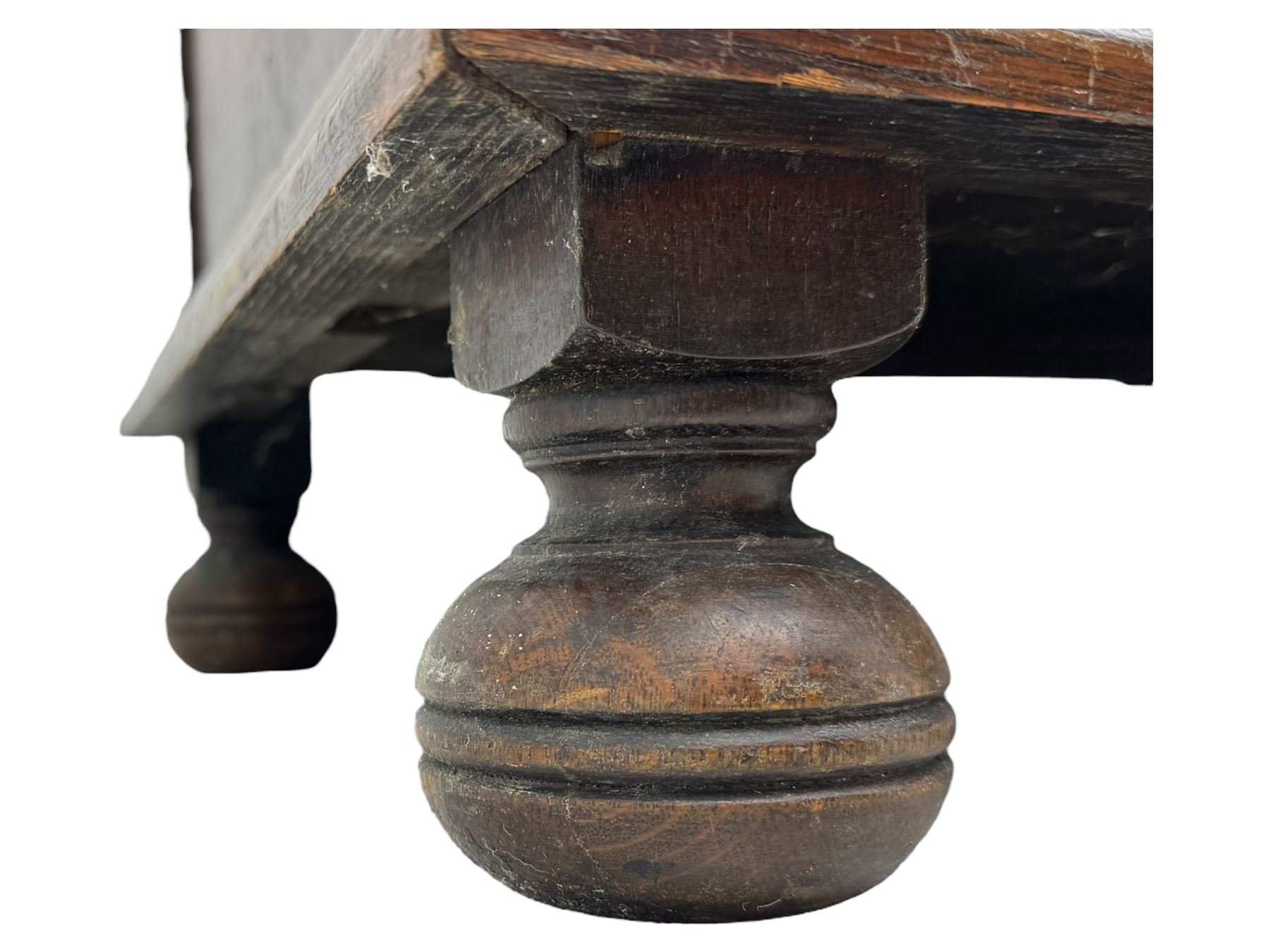 Jacobean-style oak dresser base with two frieze drawers above three cupboards with panelled and moulded decoration, fitted with drop handles, supported on bun feet, circa 1900