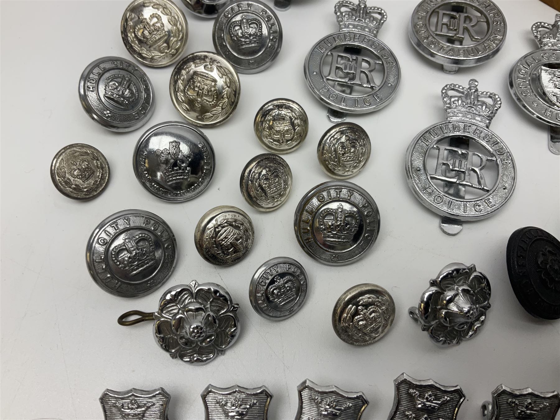 Police - large quantity of cap and collar badges, collar numbers and buttons for Hull City Police, Humberside Police, Lincolnshire Constabulary, York & North East Yorks Police etc; all queen's crown; and three helmet plates including one king's crown