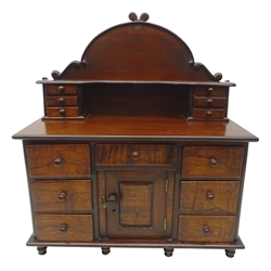  19th century miniature mahogany Lincolnshire dresser, arched back with six small drawers above seven drawers and a recessed cupboard on turned feet, L49cm x W44cm   