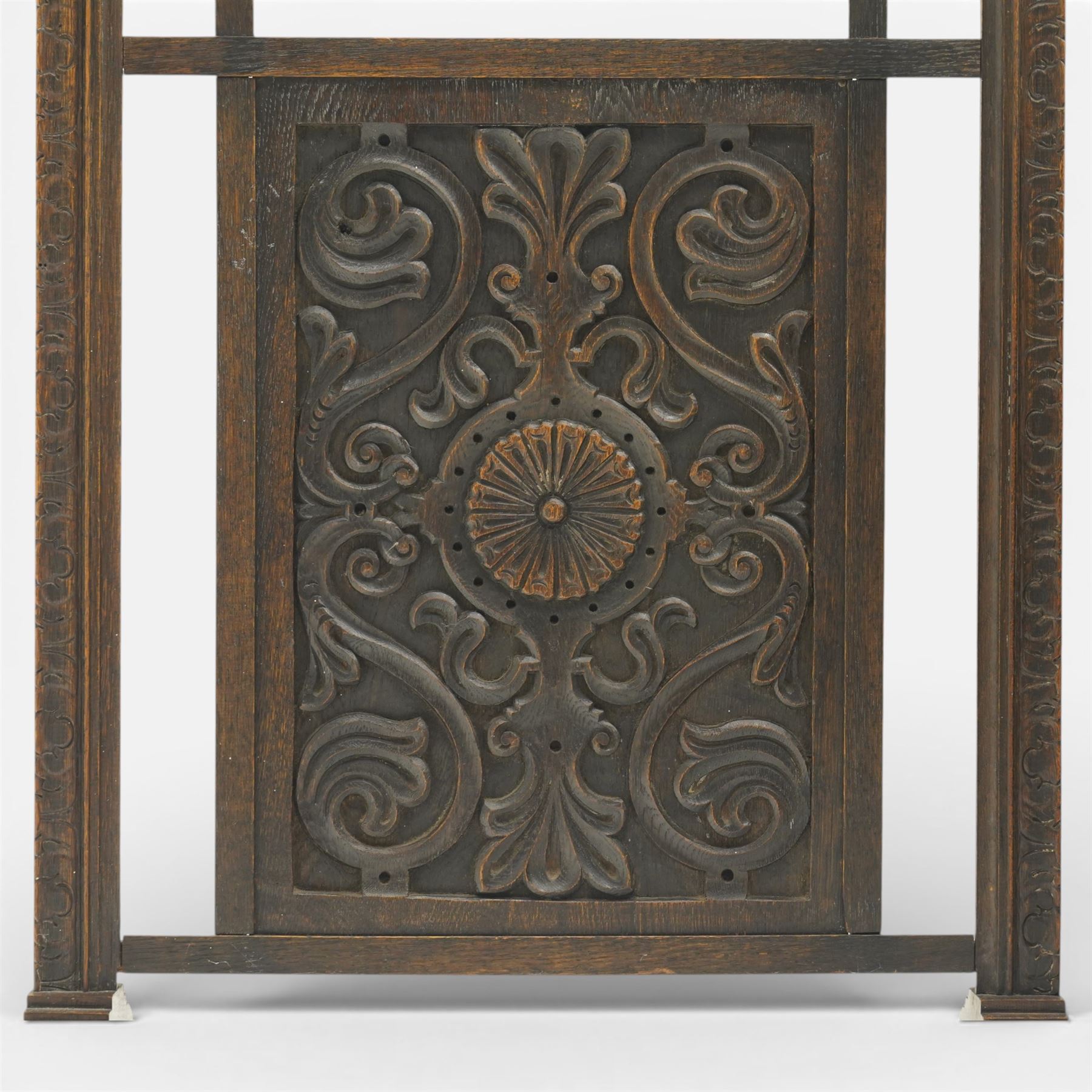 20th century carved fireside accessories; a carved coal bucket with metal liner and a carved fire screen