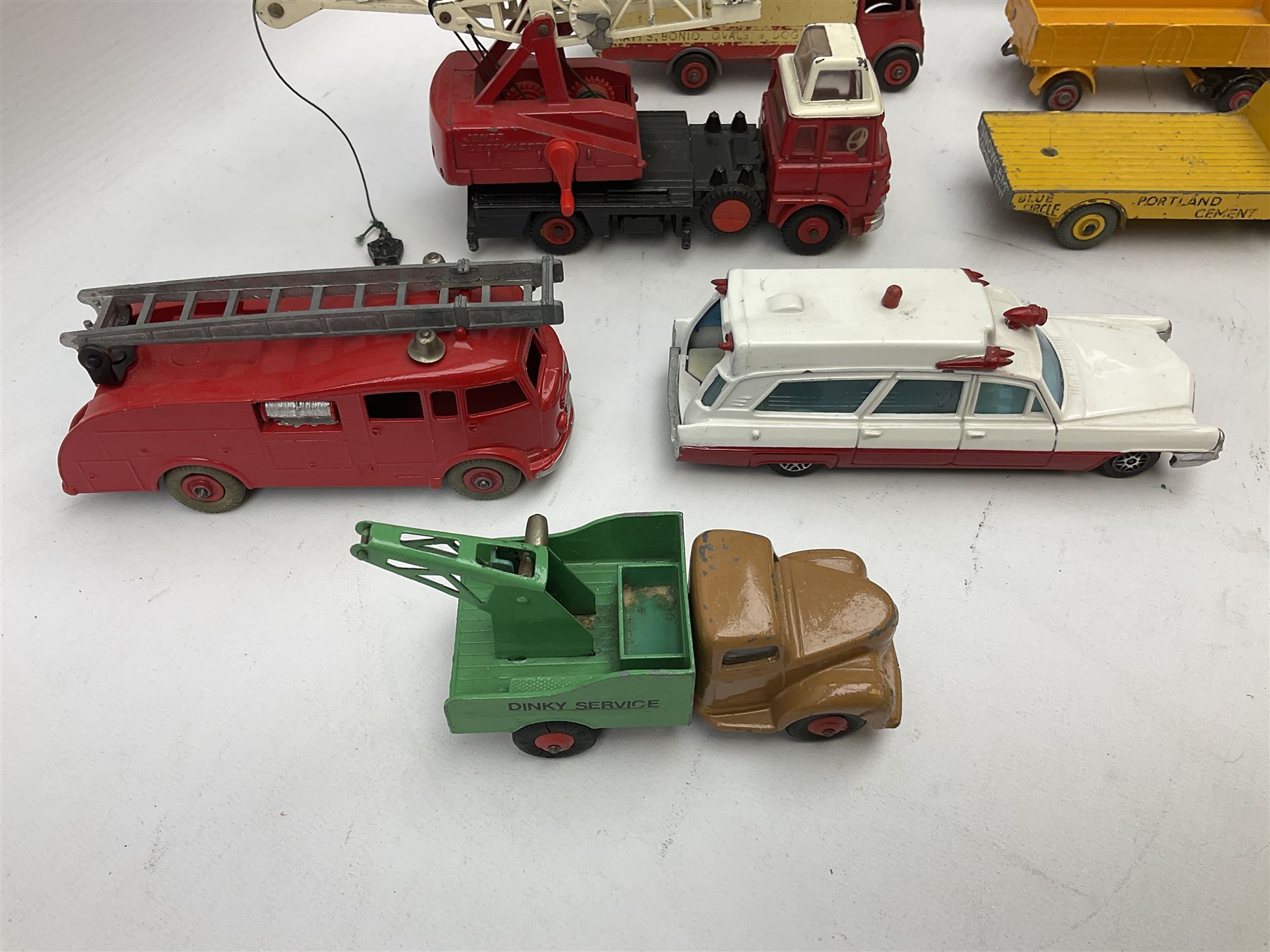 Dinky - eight unboxed and playworn/repainted commercial vehicles including Foden flatbed lorry, Bedford Articulated lorry, Leyland Comet Ferrocrete lorry, Guy Spratts panel van, Fire Engine, Jones Fleetmaster, Commer breakdown truck etc (8)