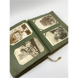 An Edwardian album containing approximately four hundred Edwardian and later postcards, to include real photographic and printed British and foreign topographical, shipping including Lusitania, Native American Indians, etc.