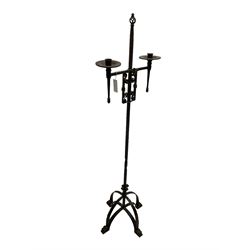 Ironwork candle holder stand, with stamped decoration, adjustable two branch sconces with scrolled iron work, twist stem with arched supports with scrolled terminals