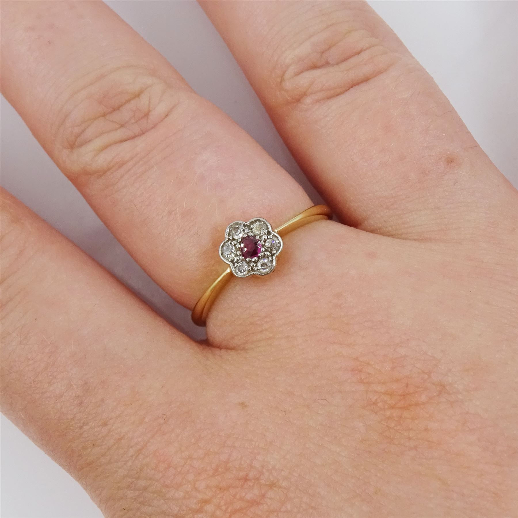Early 20th century gold ruby and old cut diamond flower head cluster ring, stamped 18ct