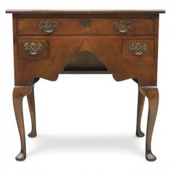 Early 20th century walnut lowboy in Queen Anne style, rectangular crossbanded top over single long drawer and two short drawers with shaped apron, fitted with brass drop handles and backplates, raised on cabriole supports terminating in pad feet