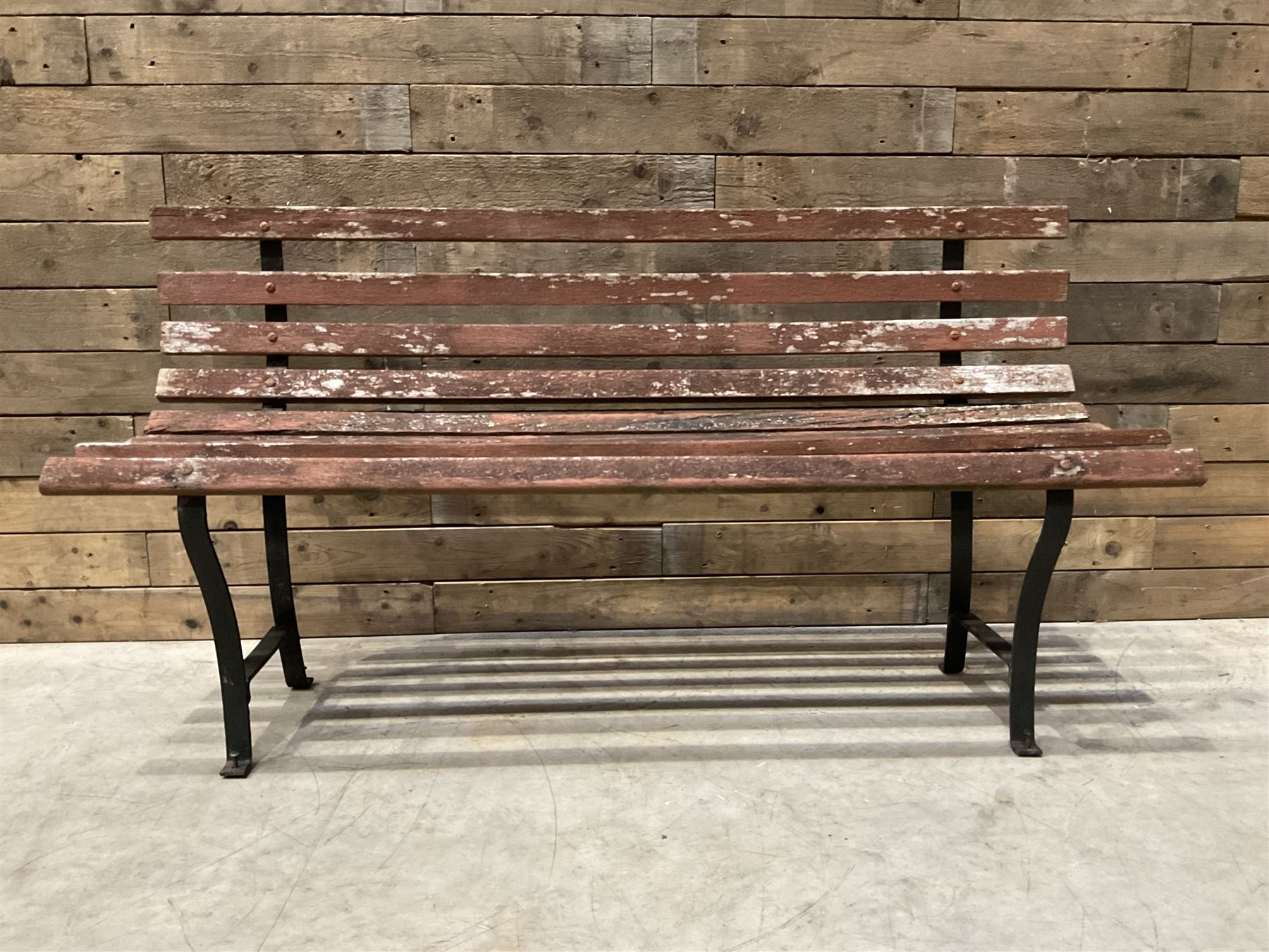 Wrought metal and wood slatted garden bench