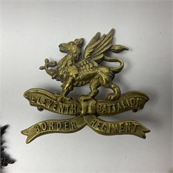 Four Border Regiment cap badges including eleventh battalion (4)