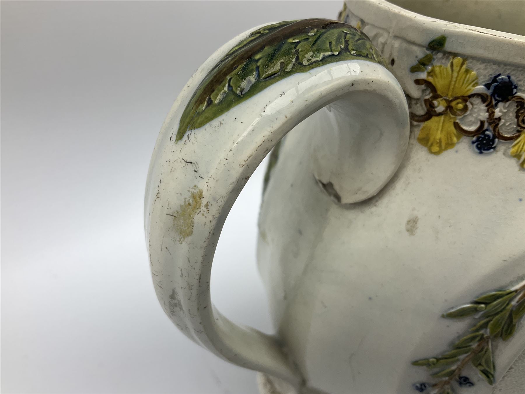 Early 19th century Prattware jug, circa 1800, decorated with two heart shaped panels of children, titled Sportive Innocence and Mischievous Sport, further decorated with acanthus and foliate borders, H22cm