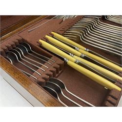 Elkington & Co part canteen of silver plated and stainless steel cutlery, to include simulated ivory handled examples, housed in oak and mahogany case, lock plate stamped 'Acme, British Made', W49cm D31cm H18cm