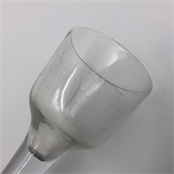 Three 18th century wine glasses comprising a plain stemmed glass with bell shaped bowl and conical folded foot H16cm, another plain stemmed glass with ogee bowl and folded foot and a Continental glass with gilt faceted bowl, decorated with male figure within a landscape, on a clear Silesian seven sided cut stem (3)