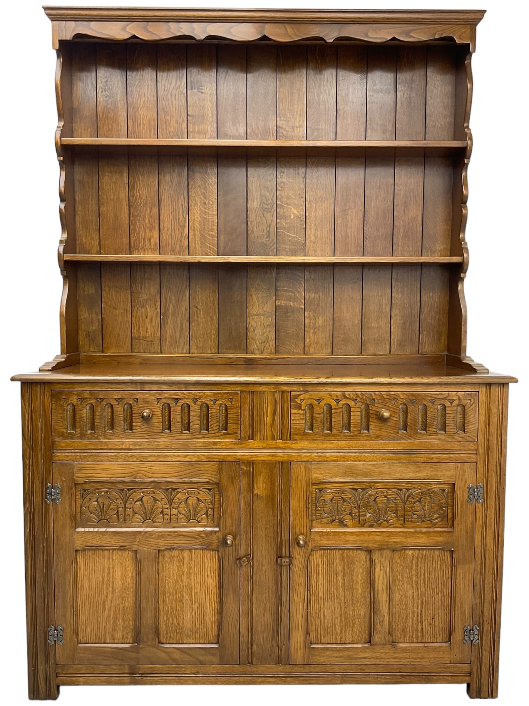 Mid-20th century oak dresser, raised two heights plate rack over two drawers and two cupboards