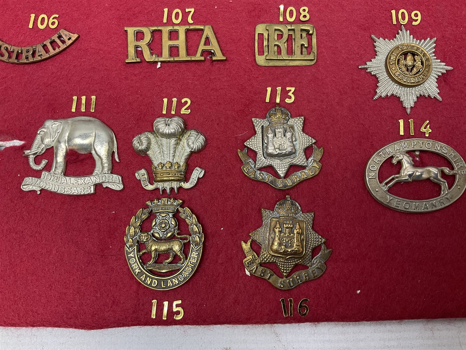 Forty glengarry and cap badges and shoulder titles including Gordon Highlanders, Canada and Canadian Field Artillery, New Zealand Field Artillery and Rifle Regiment, Shropshire Light Infantry, 14th/20th Kings Hussars, 17th Lancers, Northamptonshire Yeomanry, Royal Lincolnshire, Special Air Service, 19th Alexandra P.W.O. Hussars etc; mounted on two boards for display (2)