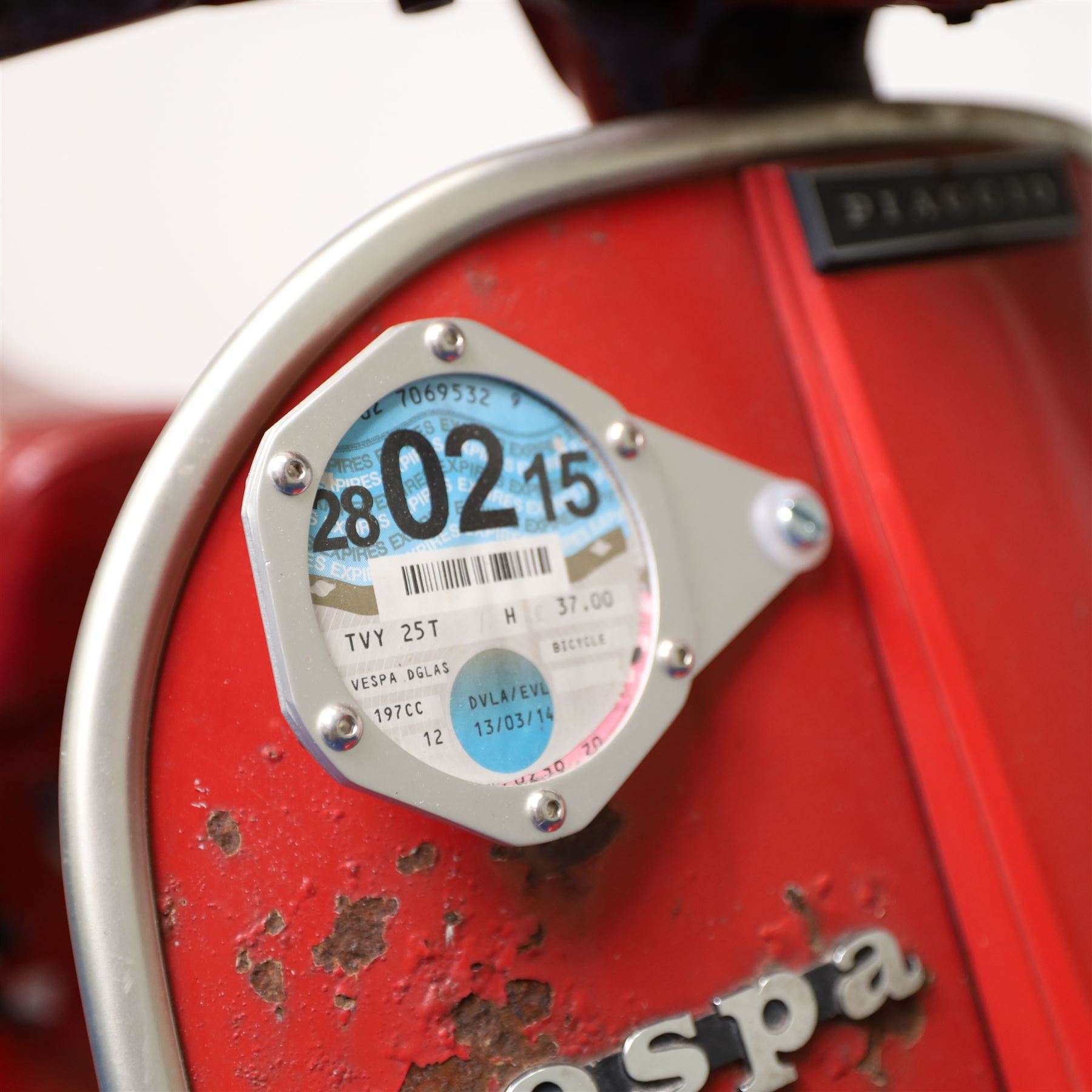 1979 Piaggio Vespa 200 Scooter

• Registration: TVY 25T
• Date of first registration: 1979
• Engine: 197cc petrol
• Odometer reading: 9,960 miles
• Colour: Red
• V5C: Present
• Keys: One

A 1979 Piaggio Vespa 200, registered TVY 25T and finished in red. Powered by a 197cc petrol engine, the scooter displays 9,960 miles on its Veglia Borletti odometer, although this mileage has not been independently verified.

The Vespa 200 is one of the larger-capacity models in the classic Vespa range, combining the marque’s distinctive pressed-steel construction with a practical 197cc engine and traditional handlebar gear change.

This example is presented in largely original and unrestored condition, retaining its period bodywork, Piaggio and Vespa badging, original-style controls and Yankee-branded dual seat.

The scooter shows extensive age-related wear throughout, including paint loss, scratches, surface corrosion and deterioration to the bodywork, including a perforation to the inner legshield.

This vehicle forms part of the Estate of the Late John Sills and is offered for sale by the Executors, confirming a genuine reason for sale.