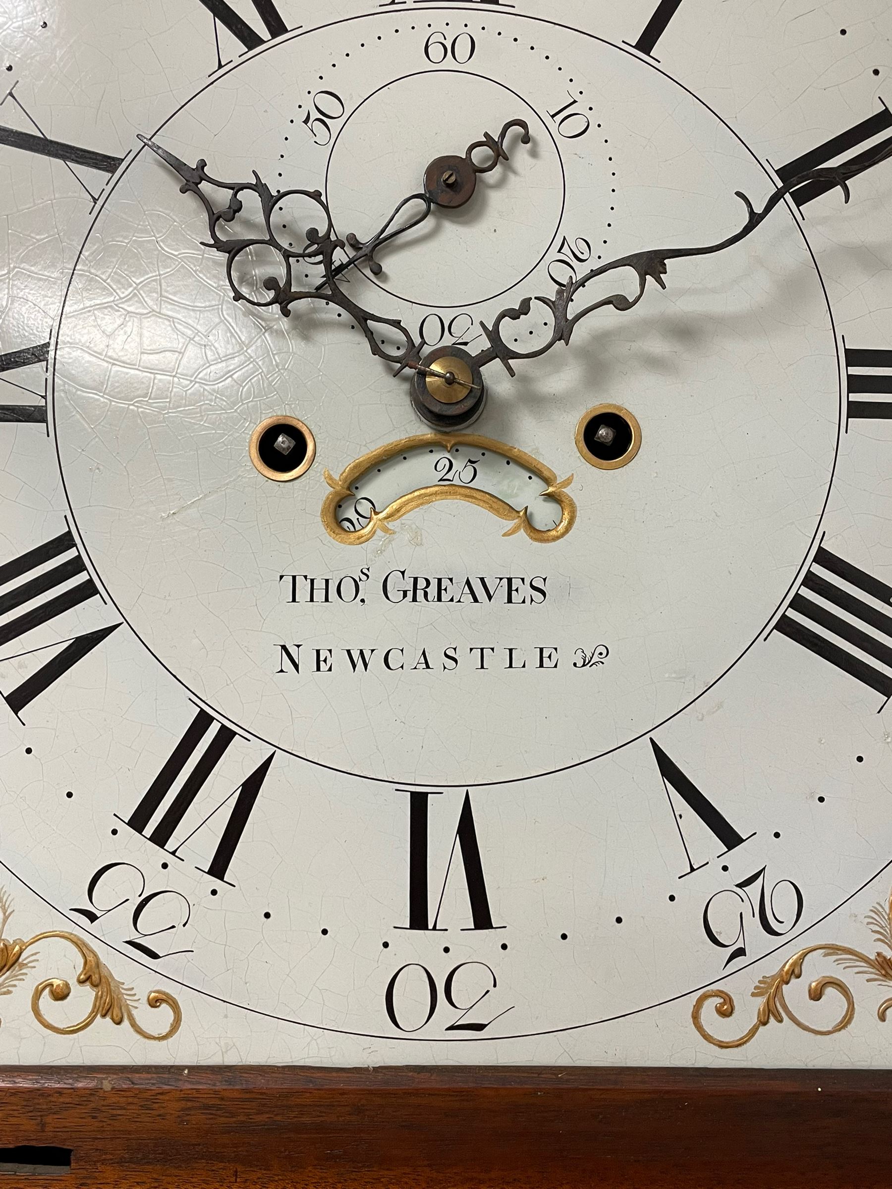 Thomas Greaves of Newcastle - late 18th century 8-day mahogany longcase clock c1790, with a flat topped hood and break arch hood door flanked by pilasters with Corinthian capitals, trunk with canted corners and ogee spire topped trunk door, rectangular plinth on a decorative stepped base,  early painted dial with raised gesso spandrels and a painted oval landscape to the arch, with matching steel hands, Roman numerals, five minute Arabic's and minute markers, subsidiary seconds dial and calendar aperture,  dial pinned via a cast falseplate to a rack striking movement with a recoil anchor escapement, striking the hours on a bell. With pendulum and weights.