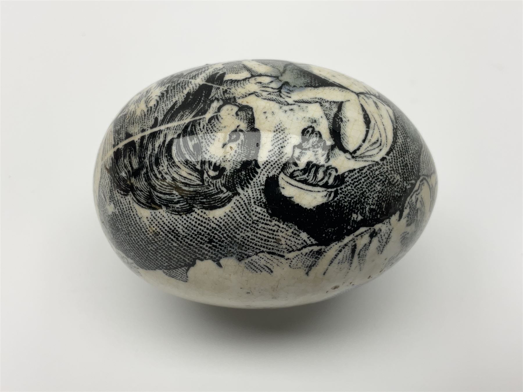Victorian pottery egg transfer, printed with scenes 'Androcles and the lion' and a courting couple, L7cm 