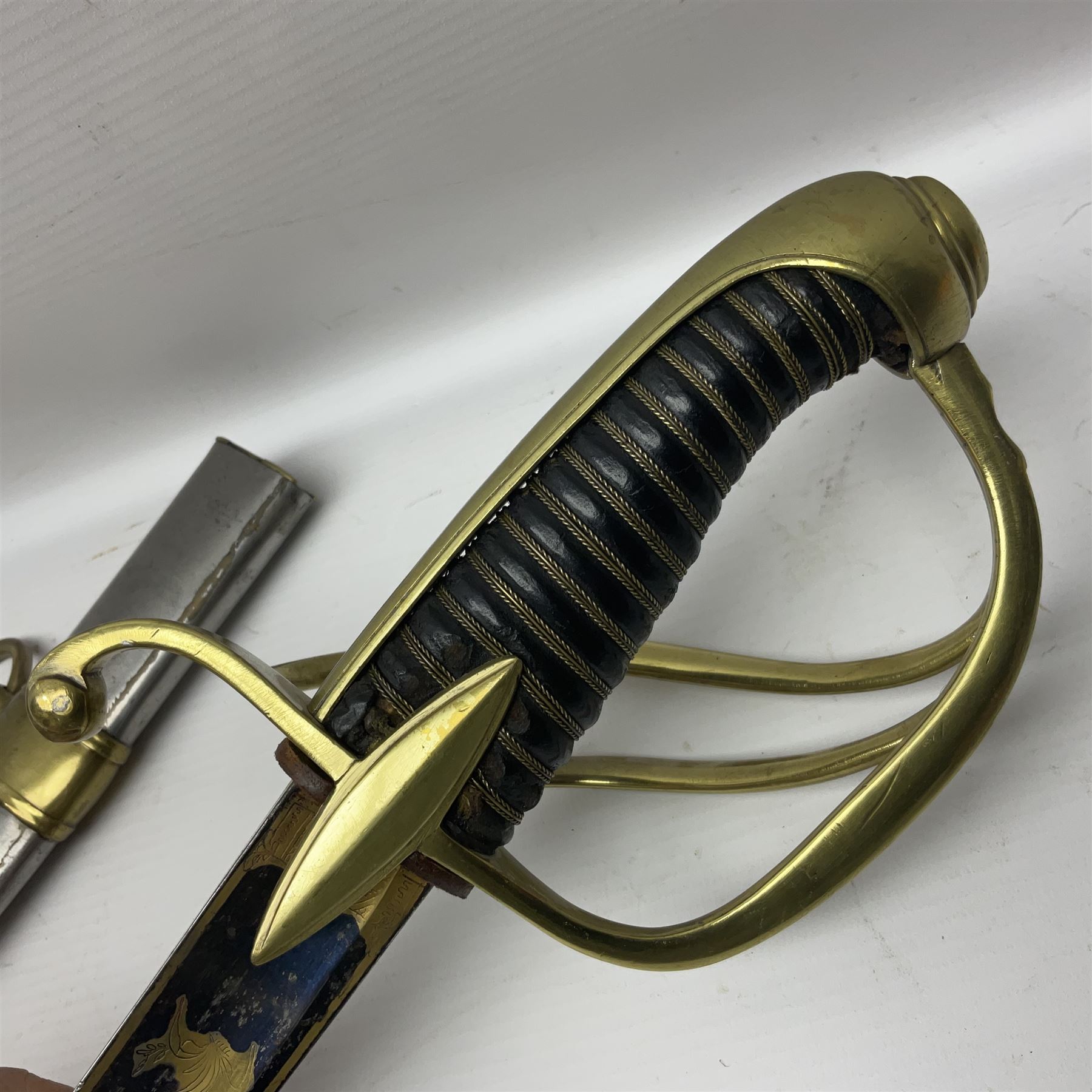 Early 19th century French Lancers officer's sword c1810, the 84cm curving fullered blade retaining most of its bluing, gilding and engraved decoration, inscribed I.S.& C. to ricasso (for Schimelbusch), brass three-bar hilt with elongated elliptical langets and wire-bound leather grip; in polished steel scabbard with two brass suspension rings L100cm overall