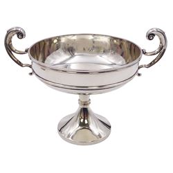 Edwardian silver twin handled trophy cup, the circular bowl with girdle and twin flying scroll handles, upon a spreading pedestal foot, hallmarked S W Smith & Co, London 1903, including handles H11.5cm, approximate weight 5.82 ozt (181.2 grams)