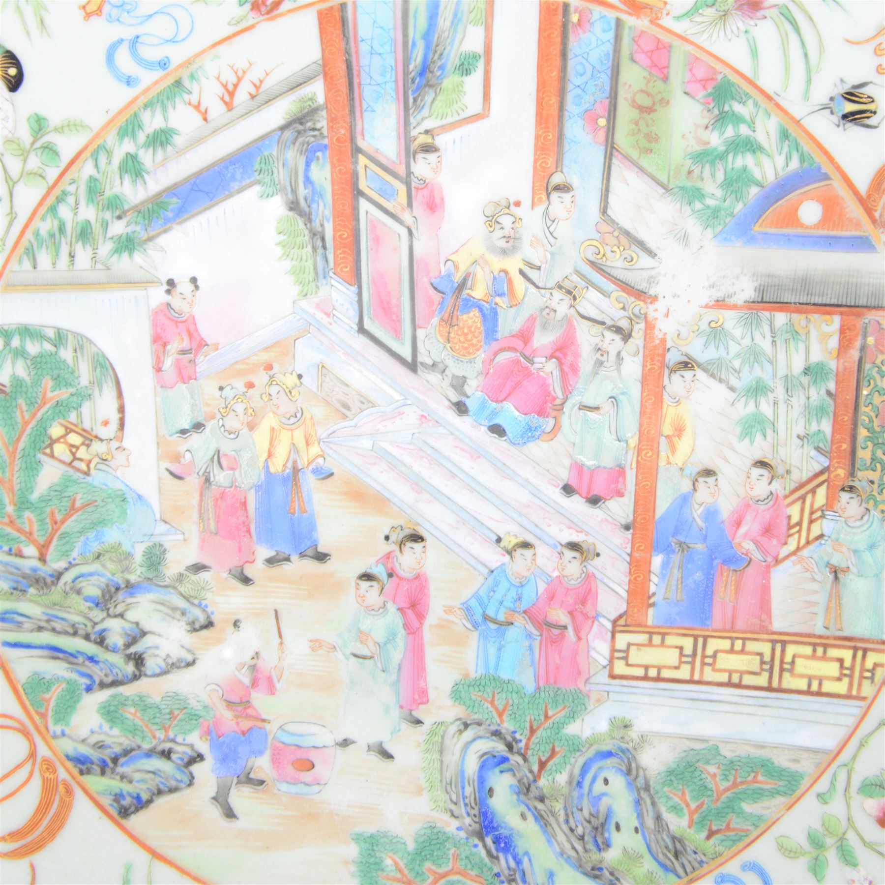 19th century Chinese Canton export celadon ground famille rose charger, of circular dished form decorated with a central panel of figures in a court setting, within a border of blossoms, birds and butterflies, D34.5cm