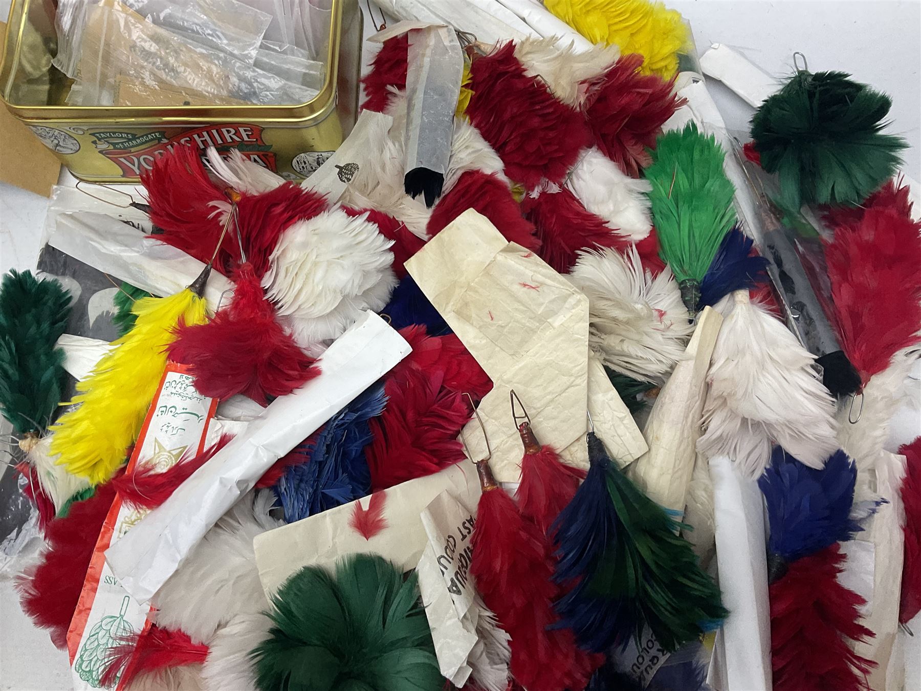 Quantity of military horse hair plumes and feather hackles, cloth stripes and regimental titles etc
