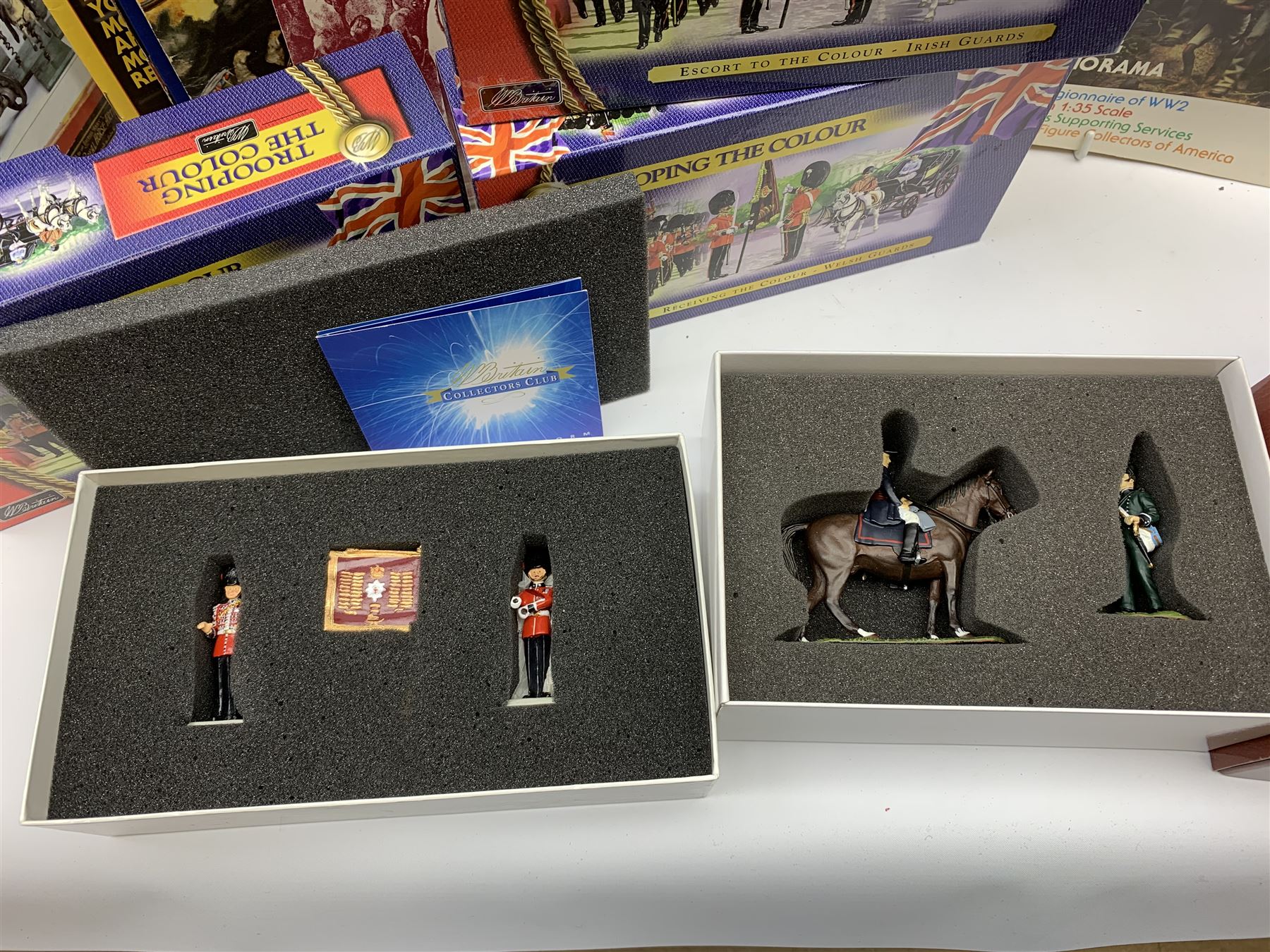 Britains - four Trooping the Colour sets 40109, 40110, 40112 & 40113; The Duke of Wellington with 95th Rifleman No.41160; and 8819 Lancer figure from the 16th Queens Lancers; all mint and boxed; together with a quantity of unboxed figures etc; and collection of books and magazines on model soldiers