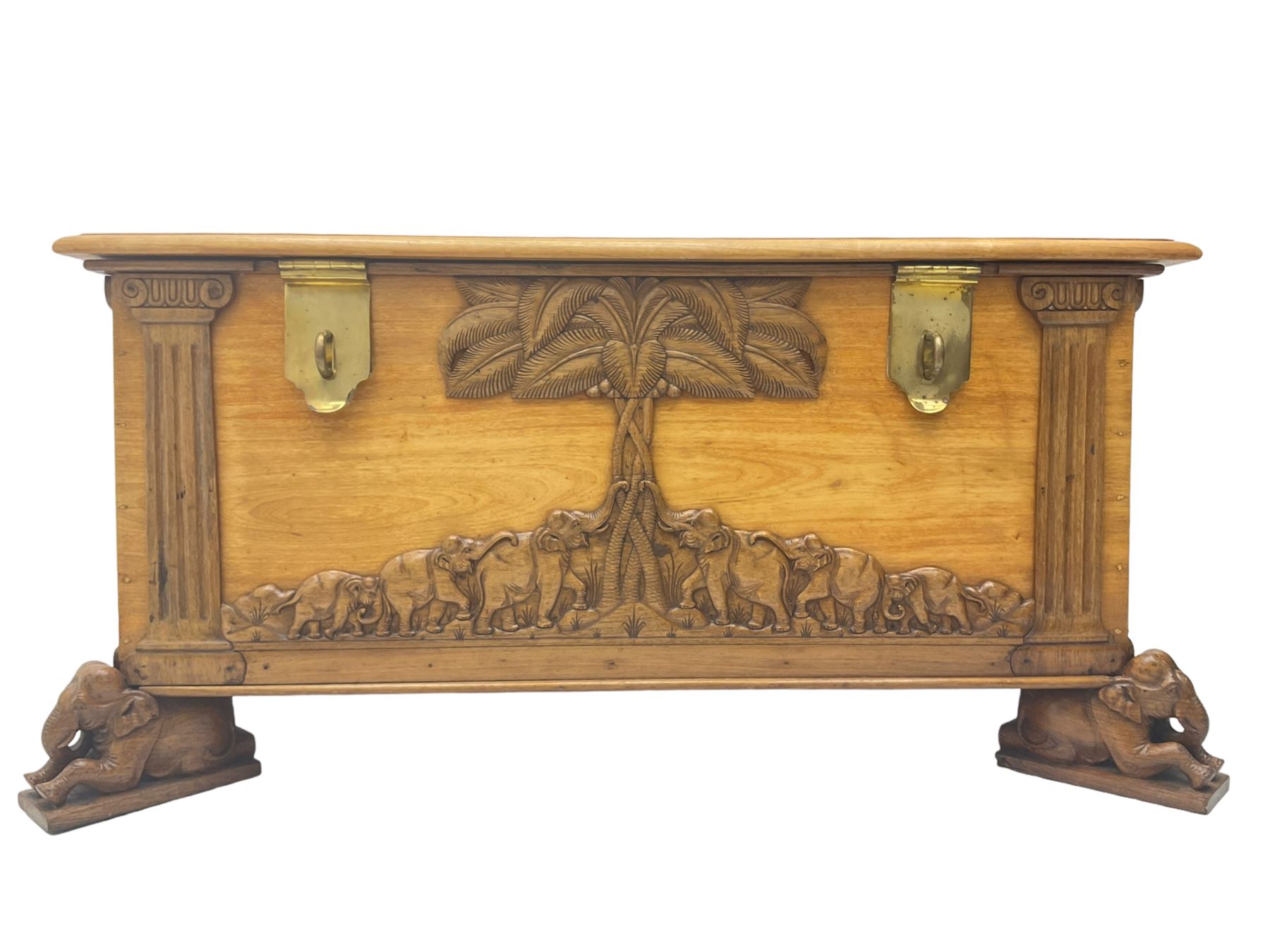 India camphor wood blanket box, moulded hinged lid, decorated with carved elephants and trees, on elephant carved feet