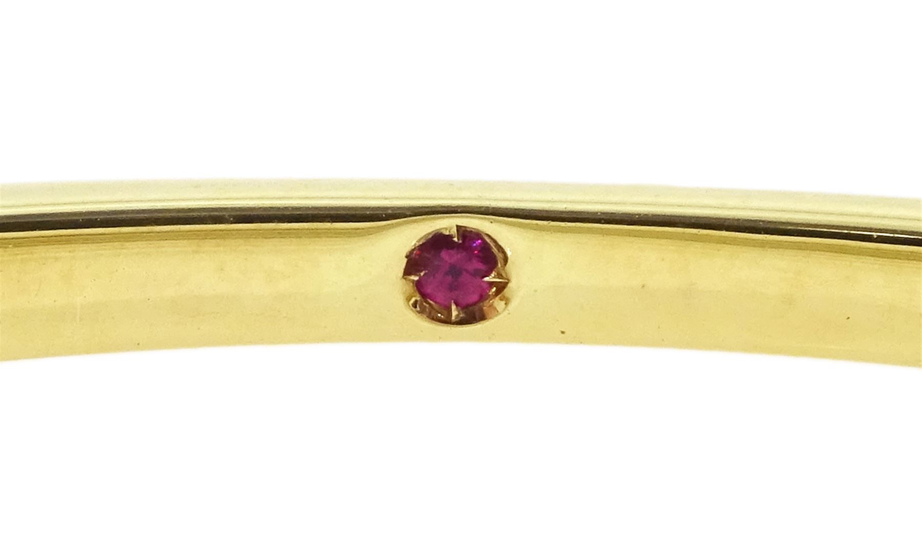 Roberto Coin 'Parisienne' 18ct gold three row round brilliant cut diamond bangle, with a signature round cut ruby to the underside and ruby set clasp, Birmingham 2006, boxed