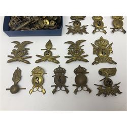 Over thirty British and Continental military metal badges; together with quantity of shoulder titles, collar dogs, rank pips, uniform buttons etc