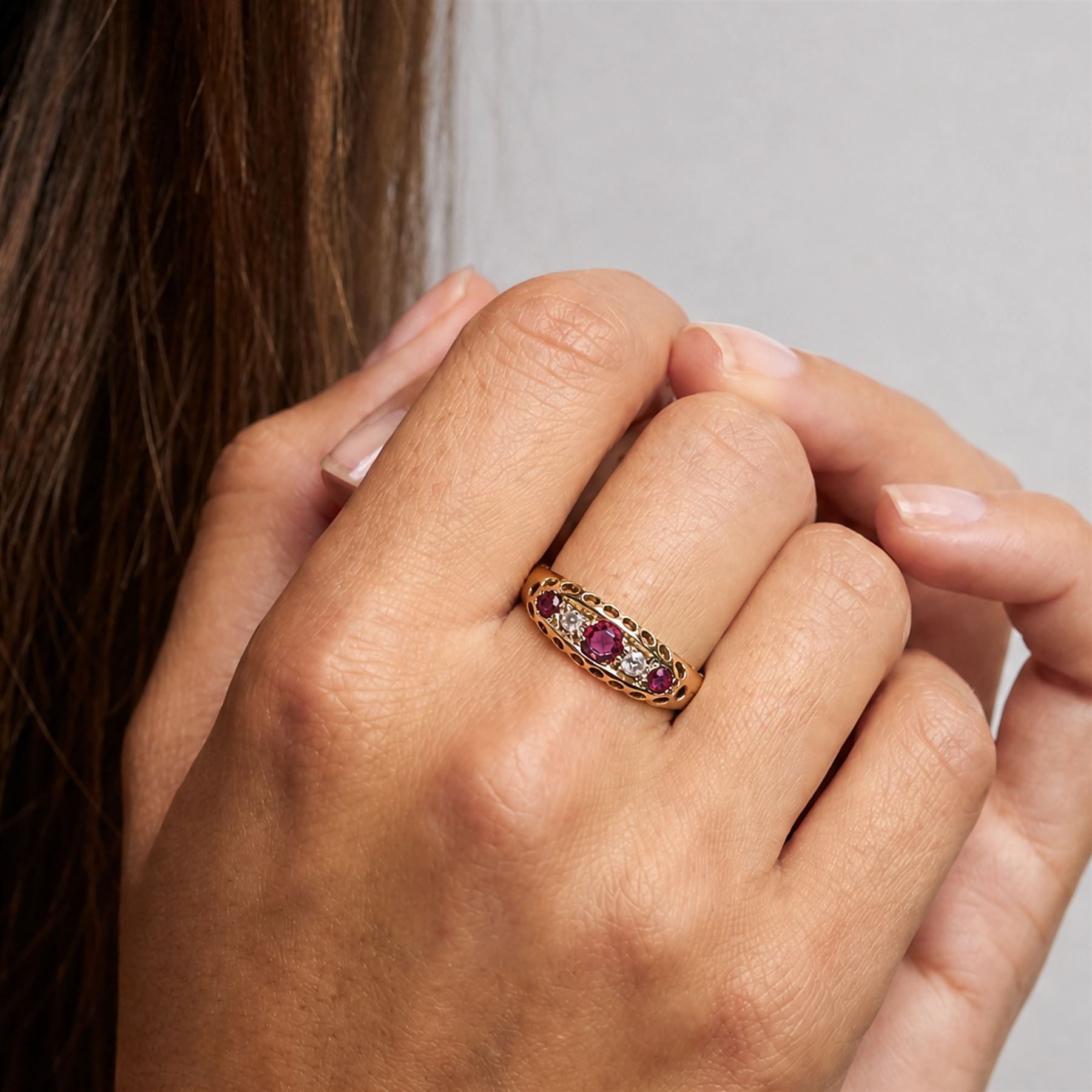 Early 20th century 18ct gold ruby and diamond ring, three round cut rubies, spaced by two old cut diamonds, Chester 1914, 