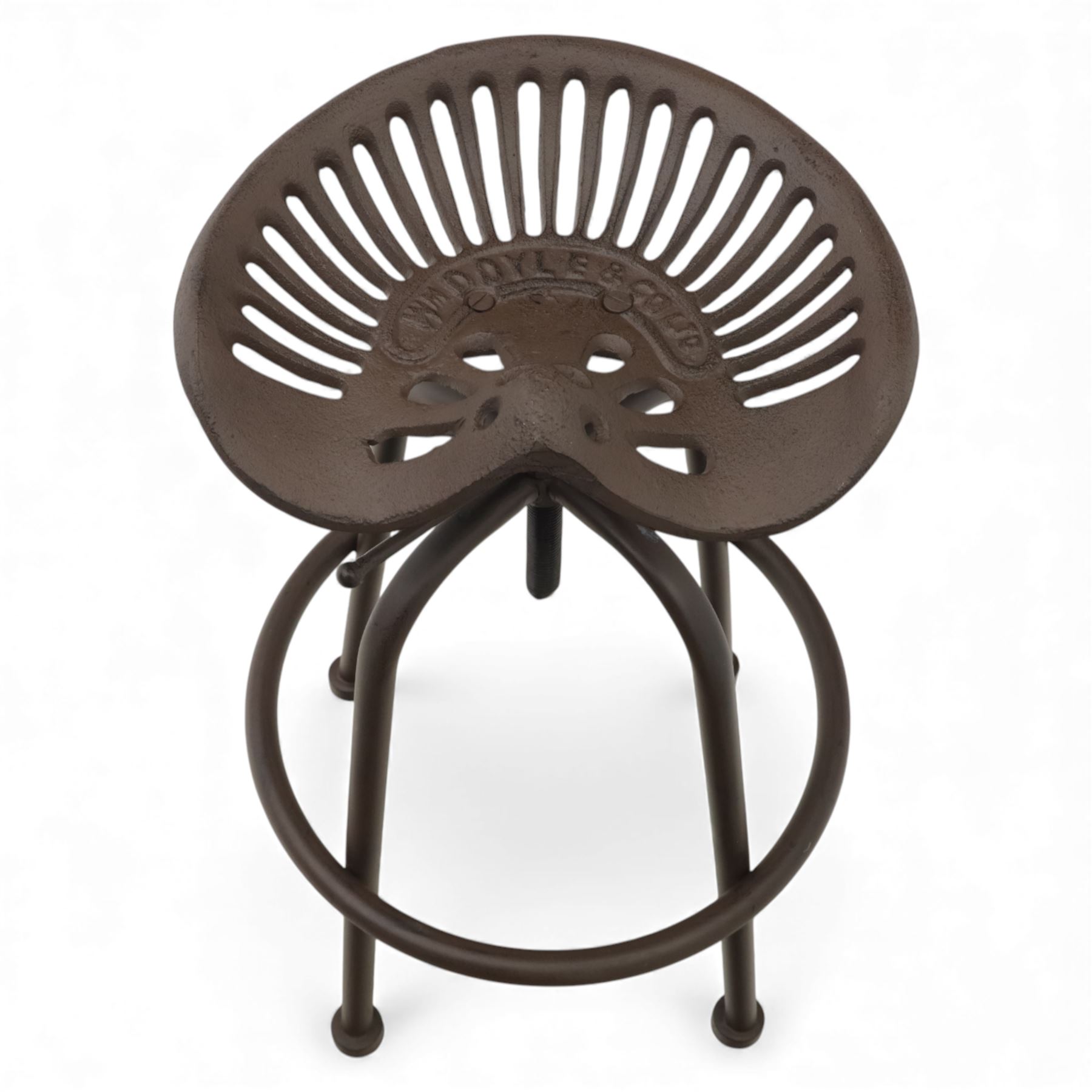 Industrial design pair of cast metal 'tractor seat' revolving bar stools, each with pierced tractor seat shaped top from the early 20th century, raised upon tubular steel supports with circular footrests (Height adjustable from 77cm - 93cm)
