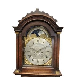 Walter Prestidge of Towcester (Northants) 8-day oak cased  longcase clock c1770,  with a break arch pediment and cresting above, conforming hood door with attached pillars and brass capitals,  long trunk door with a break arch top on a square plinth with applied skirting, brass dial with a moon disc, cast spandrels, silvered engraved dial centre and chapter ring with Roman numerals and minute track, arched date aperture and serpentine steel hands, dial pinned directly to a rack striking movement, striking the hours on a  bell. With weights and pendulum.