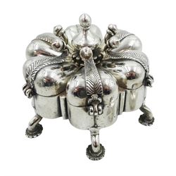 Indian silver spice box/pandan, probably 19th century, modelled in the form of a stylised flower with six lobed divisions with hinged covers, secured by a central screw threaded rod with baluster finial, upon six legs with flower pad feet, H9cm, approximate gross weight 23.79 ozt (740 grams)