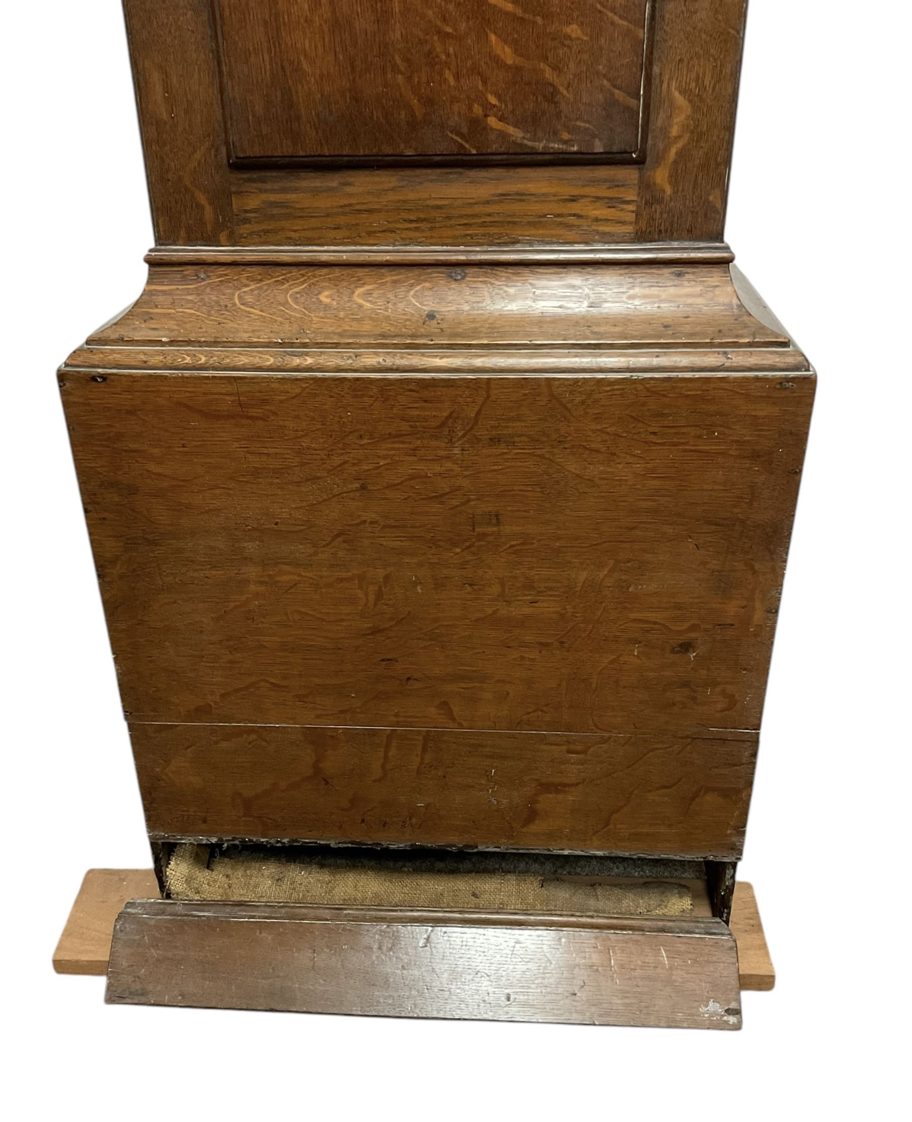 Early 19th century oak cased eight-day longcase clock c1810 - with a swan necked pediment and three matching brass finials, break arch hood door flanked by turned pilasters with brass capitals, trunk with a full length spire topped door on a square plinth with applied skirting, early painted dial with Roman numerals, Arabic five minutes, subsidiary seconds and date dials and steel hands, with floral spandrels and conforming decoration to the arch, dial pinned via a false plate to a rack striking movement, sounding the hours on a bell. With weights pendulum and key.