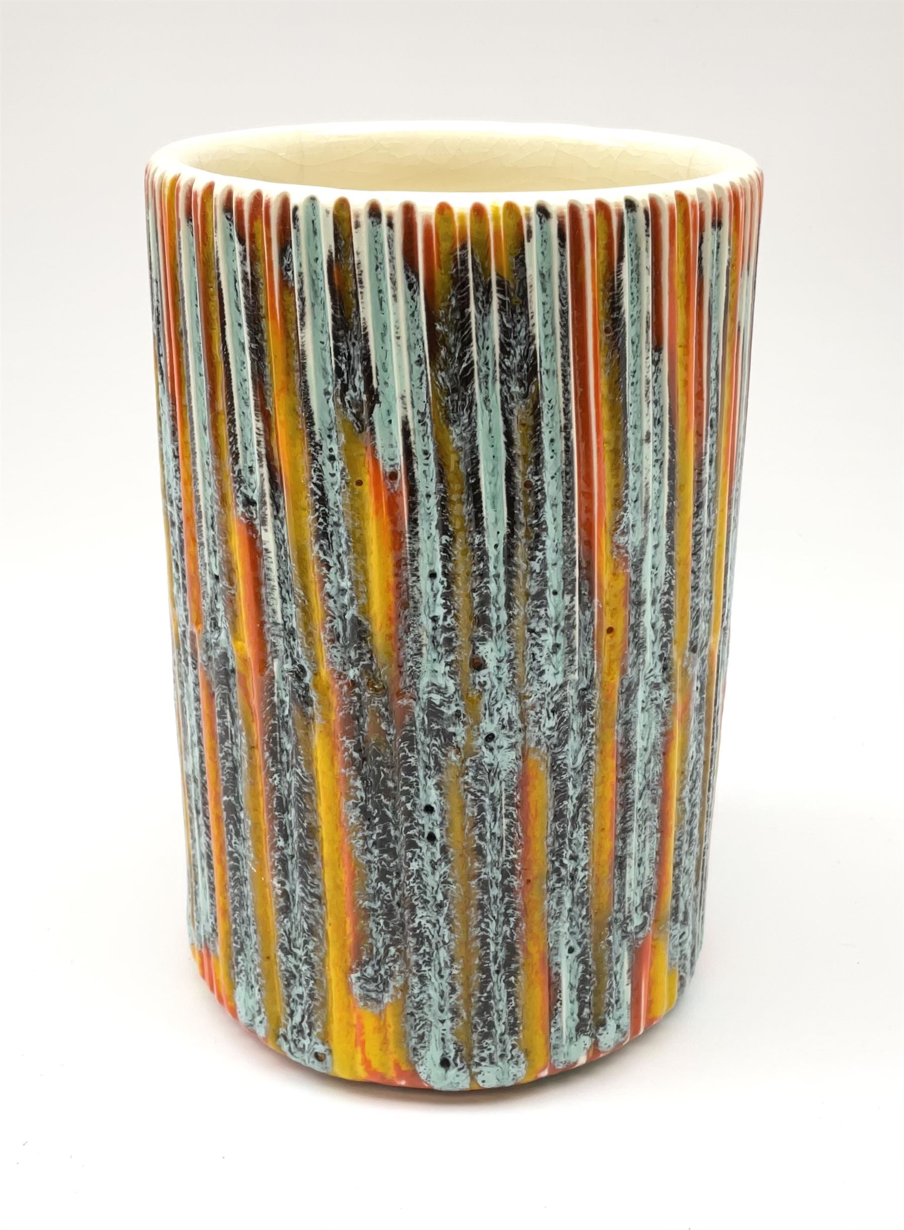 A Poole Pottery Delphis vase, shape 83, with textured effect in merging tones of red, yellow and blue, with printed mark beneath, H15cm.