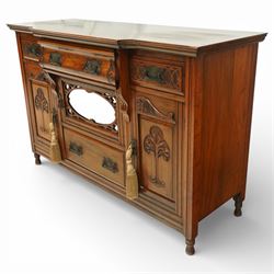 Late 20th century Art Nouveau walnut sideboard, the moulded rectangular top above a run of three drawers, the outer drawers with blind fretwork decoration and applied metal handles, the centre drawer with scroll carved terminals, below a central mirrored cupboard door with oval panel and pierced surround, flanked by carved panel doors with sinuous foliate motifs, on turned supports