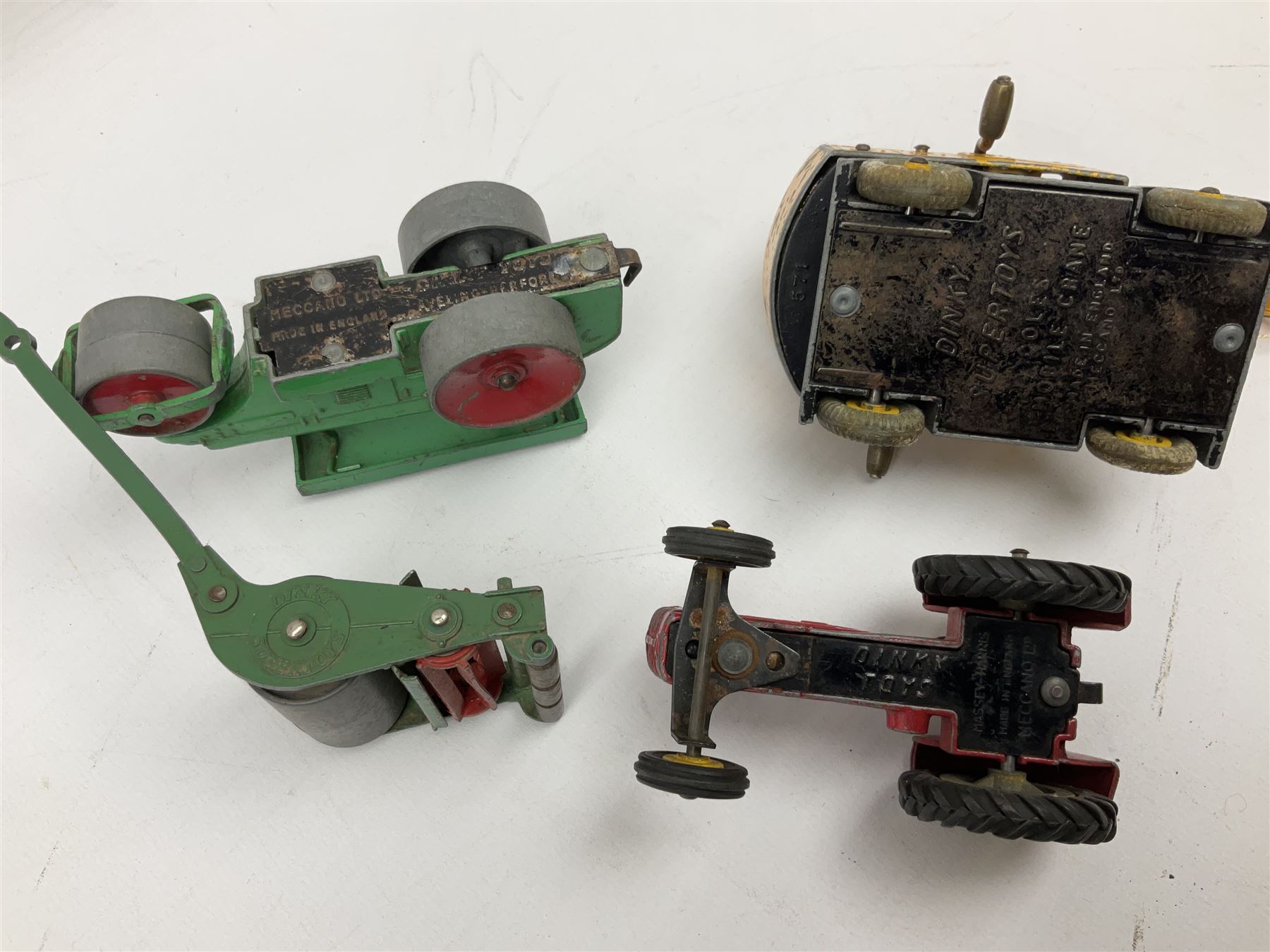 Dinky - nineteen unboxed and playworn/repainted die-cast models including Muir Hill Dumper, Muir Hill 2WL and Heavy Tractor; all repainted; Coles Mobile Crane, two Aveling-Barford steam rollers; Massey-Harris tractor and manure spreader; Land Rover; nine various trailers etc (19)