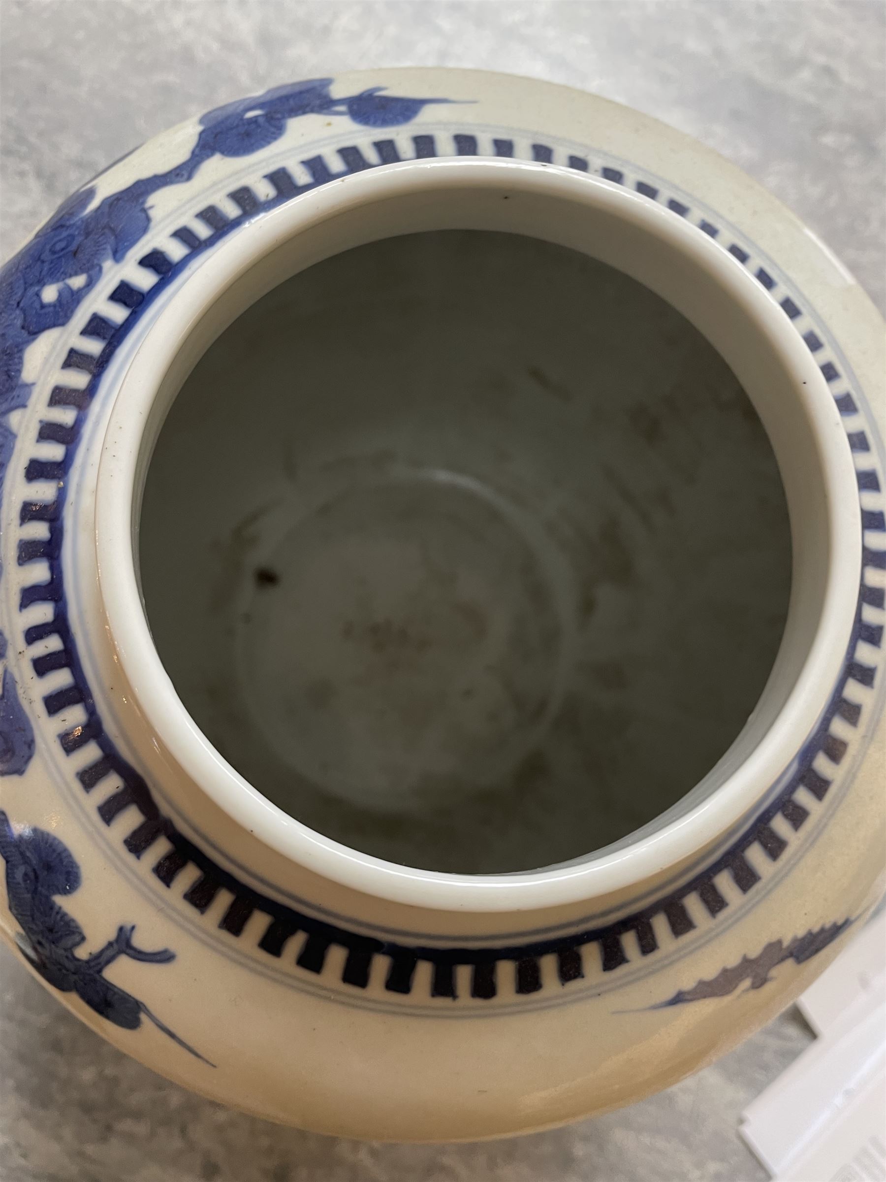 Late 19th century Chinese blue and white ginger jar, of ovoid form with flat topped circular cover, the body decorated with a geisha on reindeer with attendant in a landscape setting, with apocryphal Kangxi mark beneath, H24cm