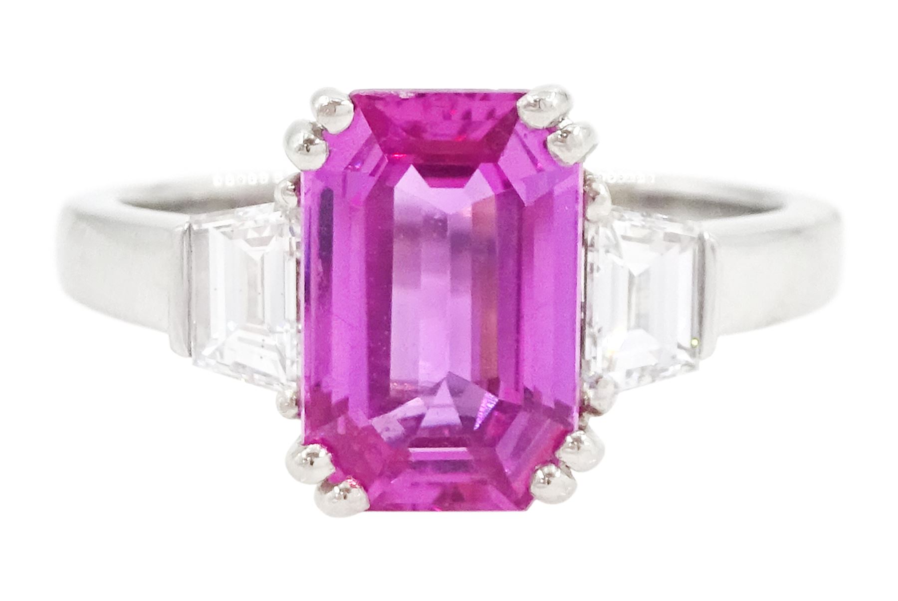 Platinum unheated pink sapphire and diamond three stone ring, emerald cut unheated sapphire of approx 3.16 carat, with a single trapeze cut diamond set either side, London 2014, total diamond weight approx 0.71 carat, with Alan Poultney Gems report, the sapphire with The Gem & Pearl Laboratory report