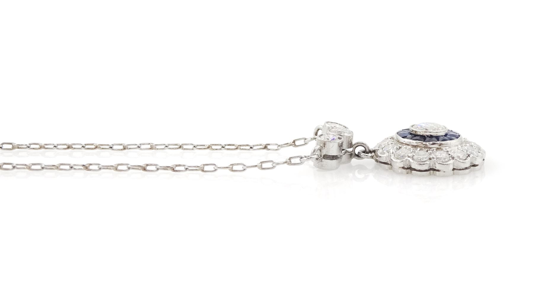 Platinum sapphire and diamond necklace, milgrain set round brilliant cut diamond and calibre cut sapphire cluster, suspending from three round brilliant cut diamonds, to a trace link chain necklace, total diamond weight 0.65 carat, total sapphire weight approx 0.30 carat