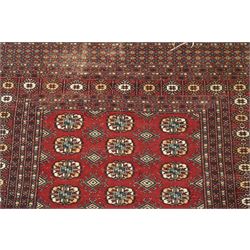 Two hand-knotted rugs, comprising Turkoman Ersari rug and Bokhara rug, Turkoman Ersari hand-knotted rug, terracotta ground with two rows of repeating octagonal guls interspersed with geometric motifs, enclosed by multiple geometric borders, fringed ends, H125cm, W93cm; Bokhara hand-knotted rug, madder red ground with three rows of repeating Tekke guls interspersed with geometric motifs, enclosed by multiple stylised floral and geometric borders, fringed ends, H188cm, W126cm
