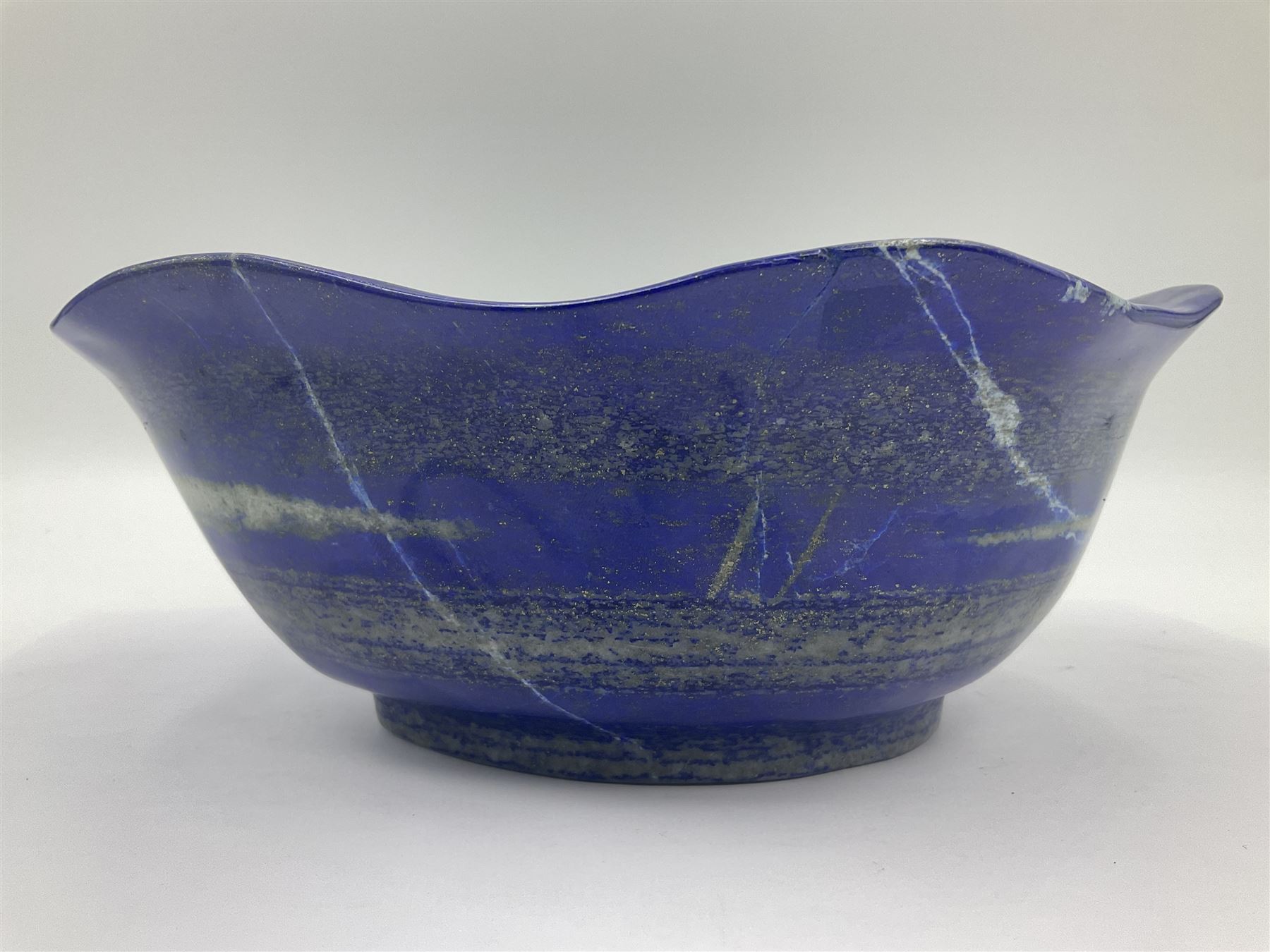 Carved bowl, flat-bottomed bowl carved from a single piece of Lapis lazuli with flared rim, H8cm, L21cm