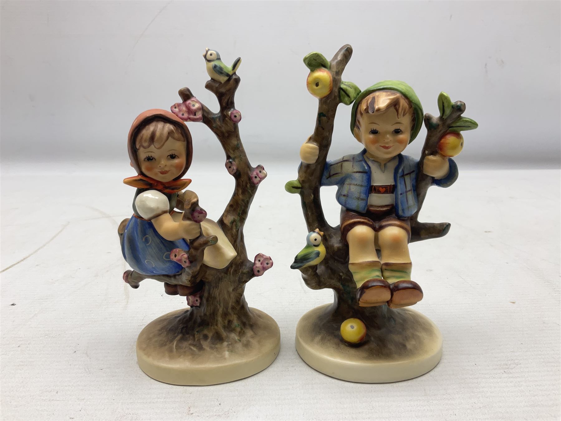 Seven Goebel Hummel figures, comprising Chimney Sweep 12/I, Apple Tree Girl 14/I, Apple Tree Boy,  Little Goat Herder 200/I, Surprise 94 3/0, Signs of Spring 203/20 and Wayside Harmony 111/30, tallest H15cm